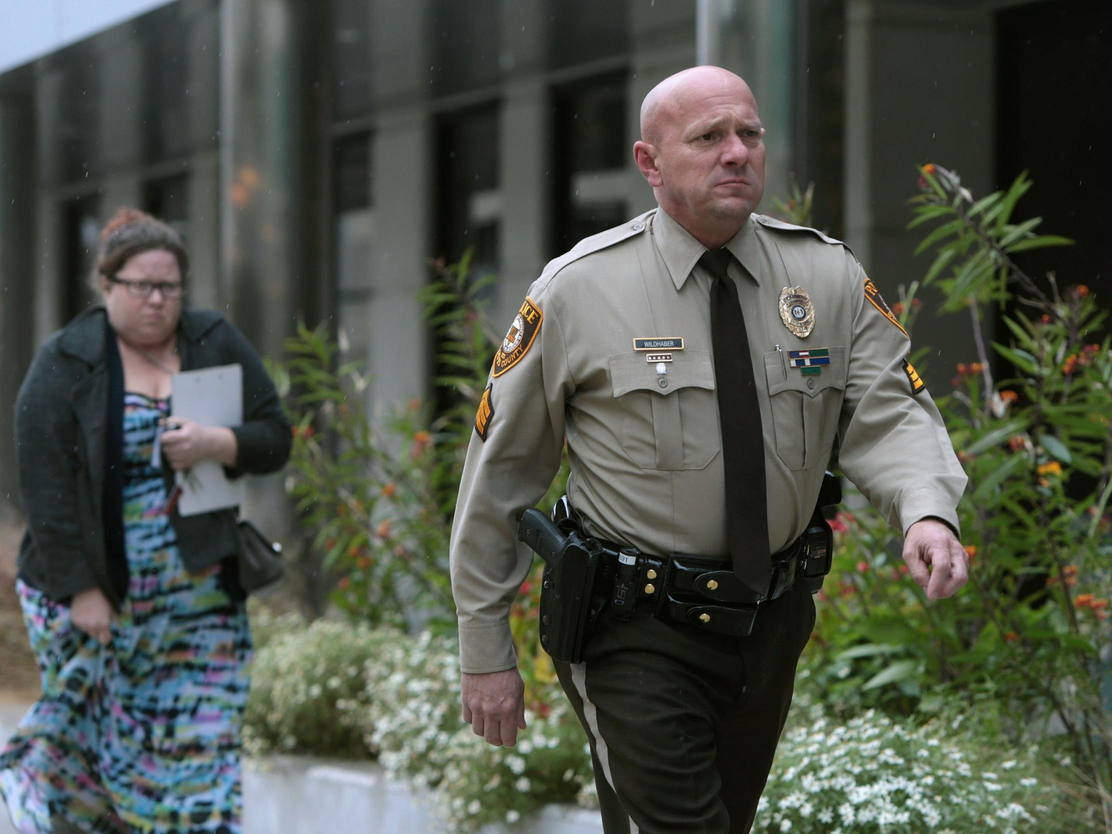 Oct. 24, 2019 file photo, St. Louis County police Sgt Keith Wildhaber returns from a lunch break to the St Louis County courthouse on the third day of his discrimination case against the county in Clayton Missouri St. Louis County