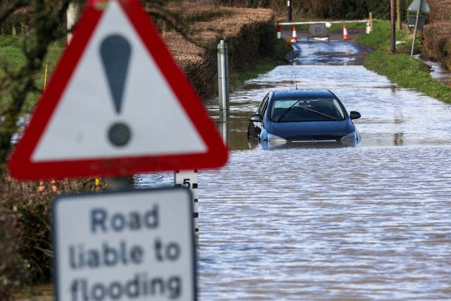 A car is stuck in flood water near Peasmarsh, Somerset, where heavy overnight rainfall caused the nearby River Yarty to rise, 13 February, 2020.