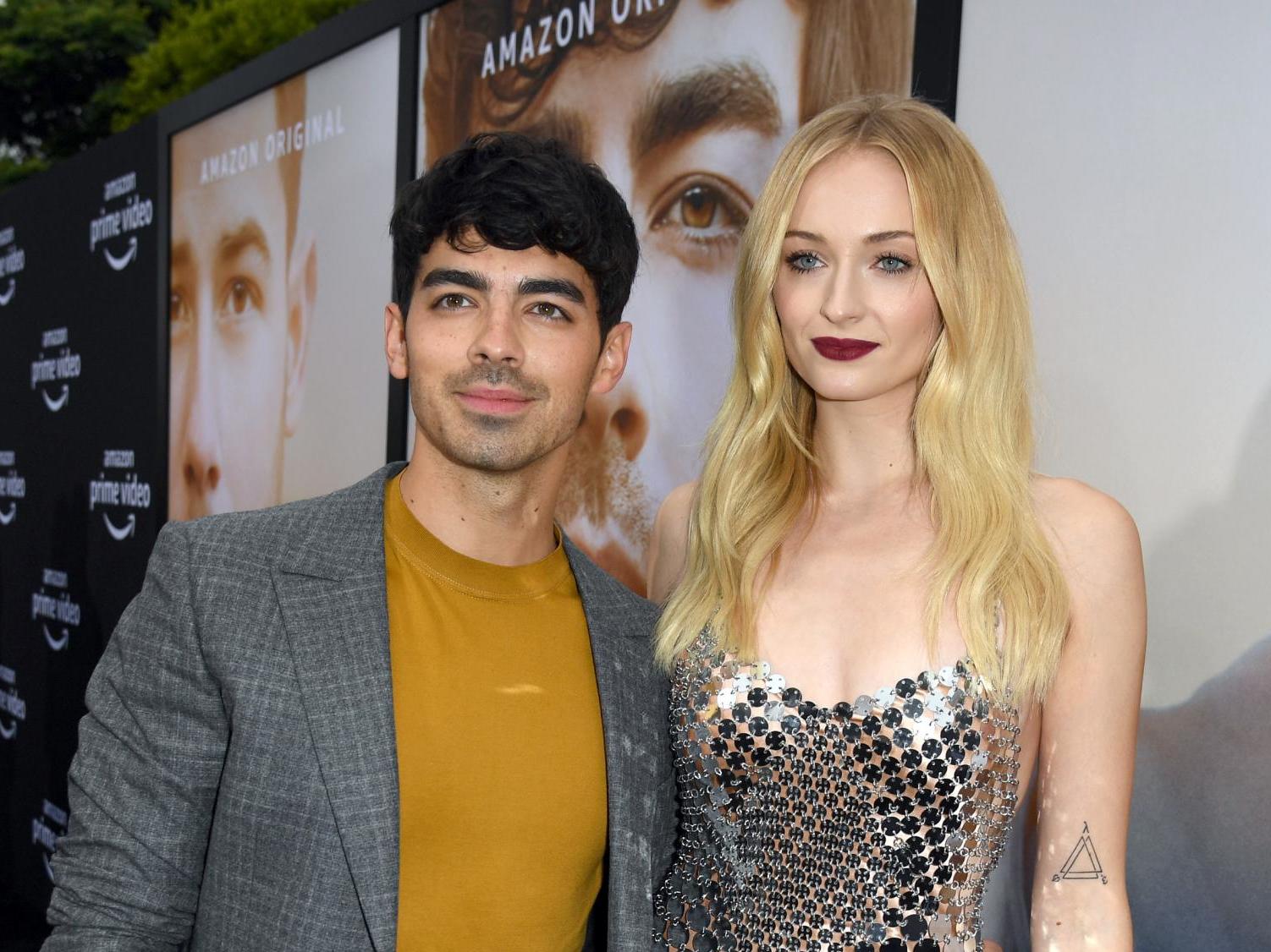 Sophie Turner Turns a T-Shirt Into a Dress in Sheer Tights
