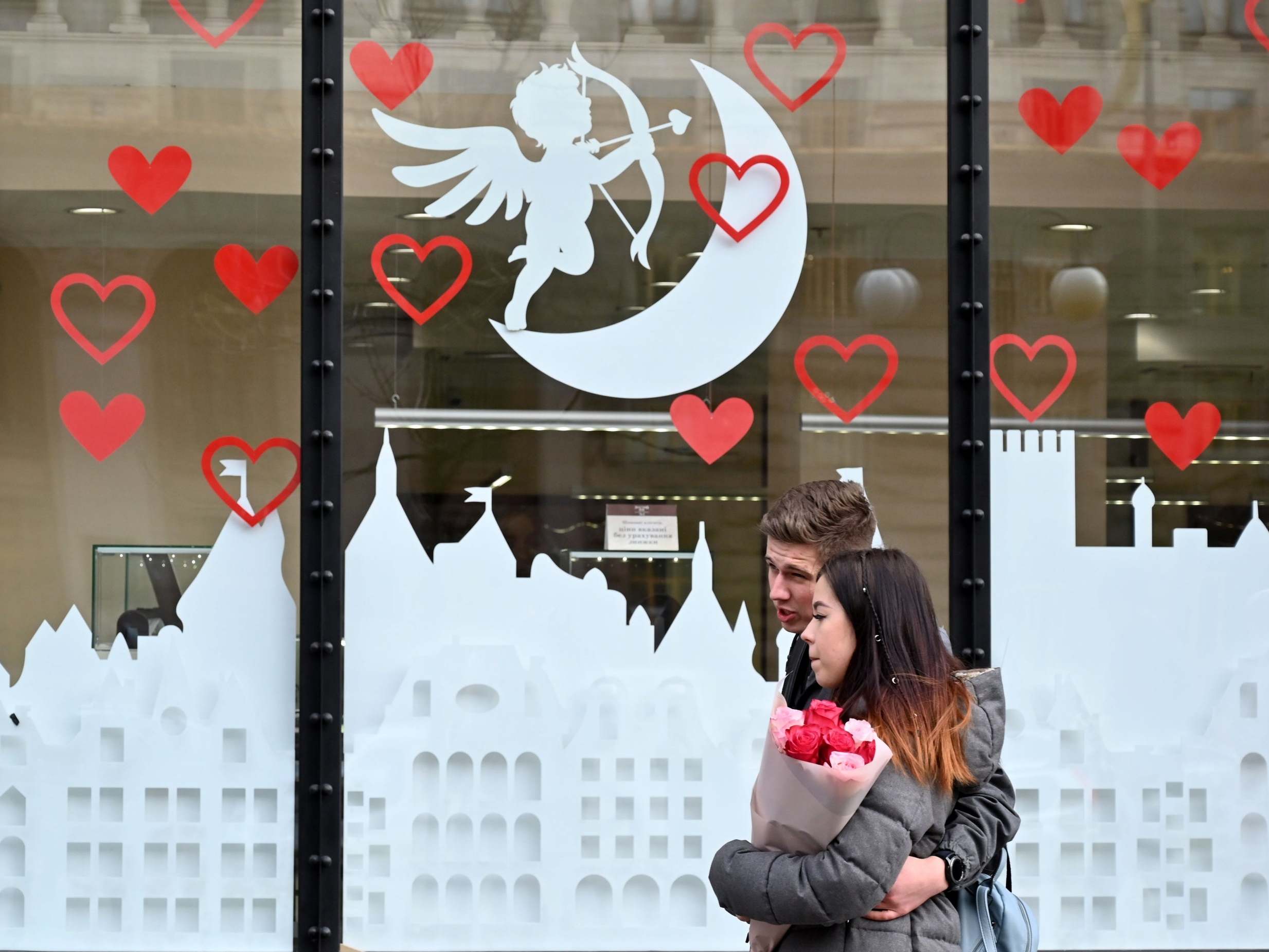 A couple walk down the street on Valentine's Day