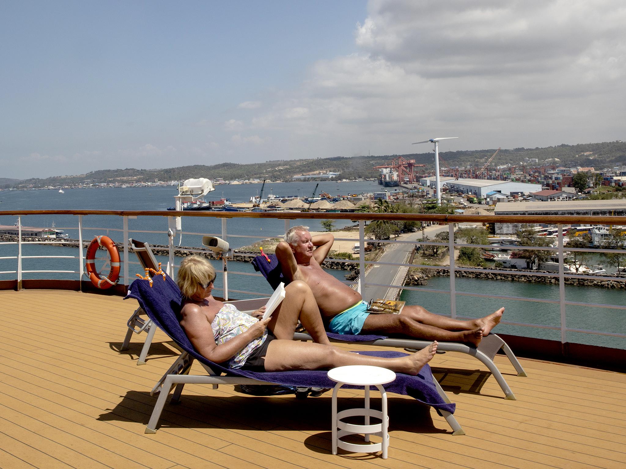 Passengers relax onboard the MS Westerdam before docking in Sihanoukville, Cambodia