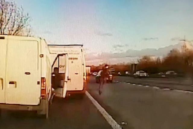 Dashcam footage shows moment thief escaped from cops - by sprinting across six lanes of motorway traffic