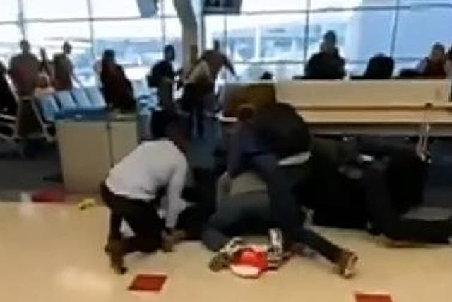 Bystanders captured footage of altercation which saw man take a swing at airport security