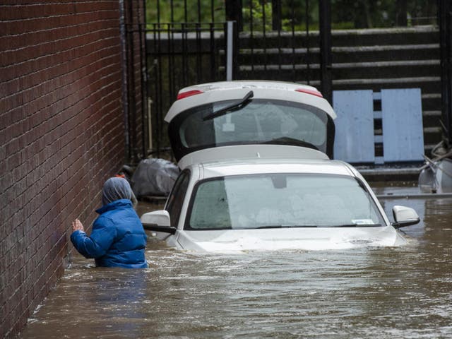 A boy wades through floodwater in Pontypridd, South Wales, at the weekend