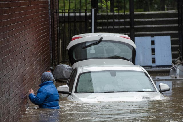 A boy wades through floodwater in Pontypridd, South Wales, at the weekend