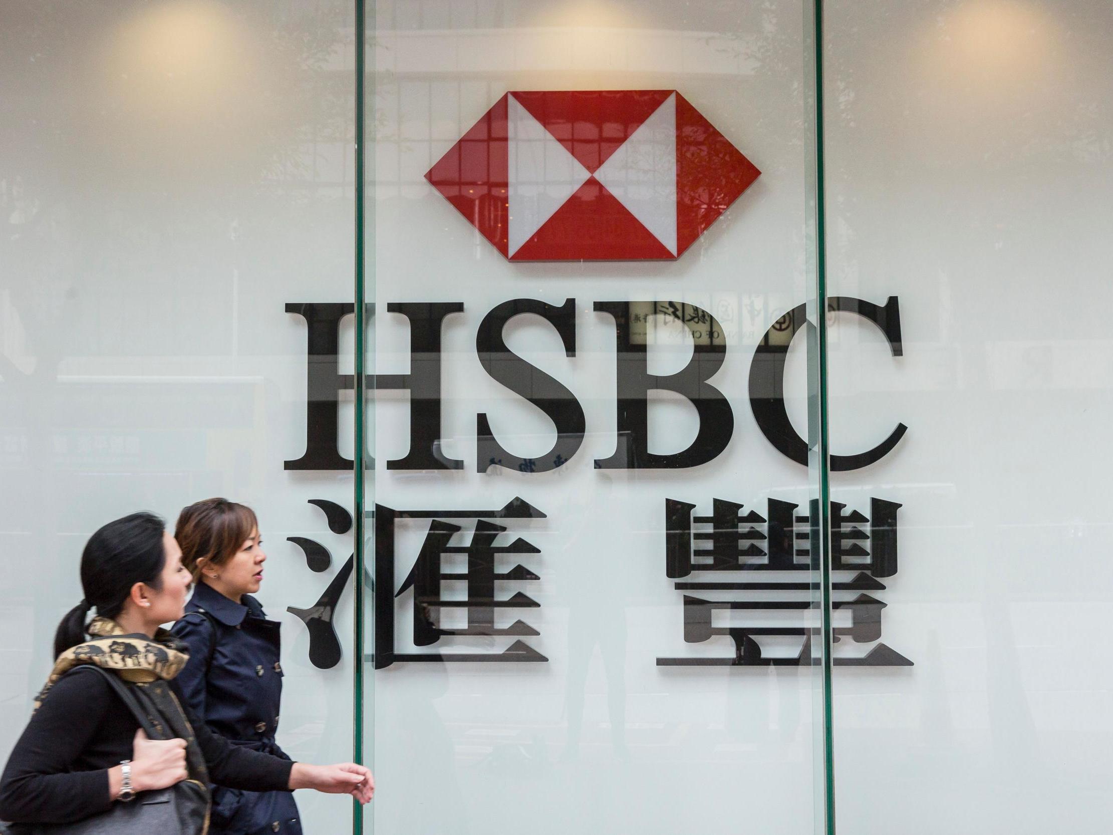Pedestrians walk past HSBC in Hong Kong, where the bank was founded