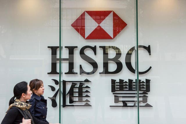 Pedestrians walk past HSBC in Hong Kong, where the bank was founded