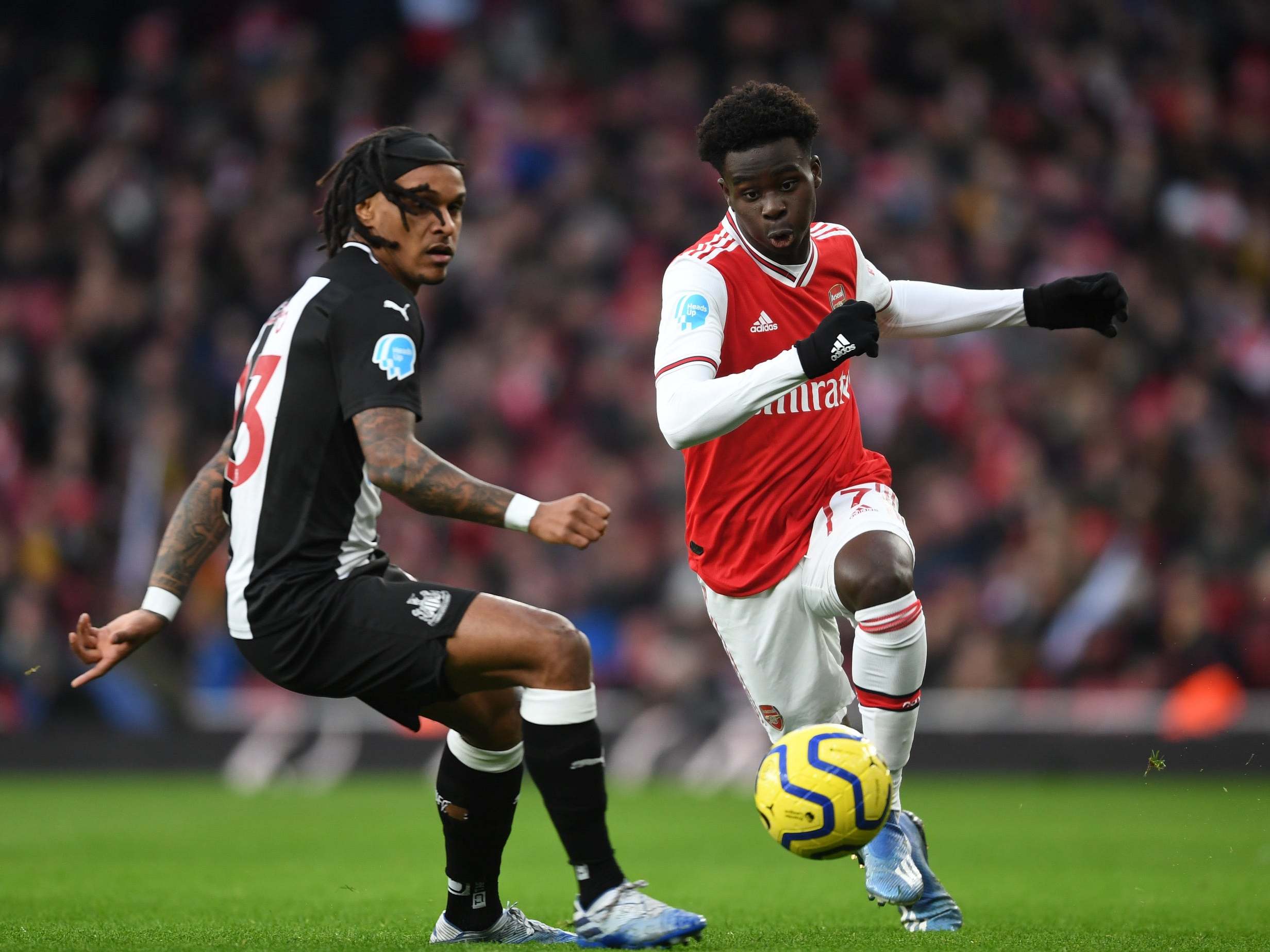 Bukayo Saka of Arsenal takes on Valentino Lazaro of Newcastle