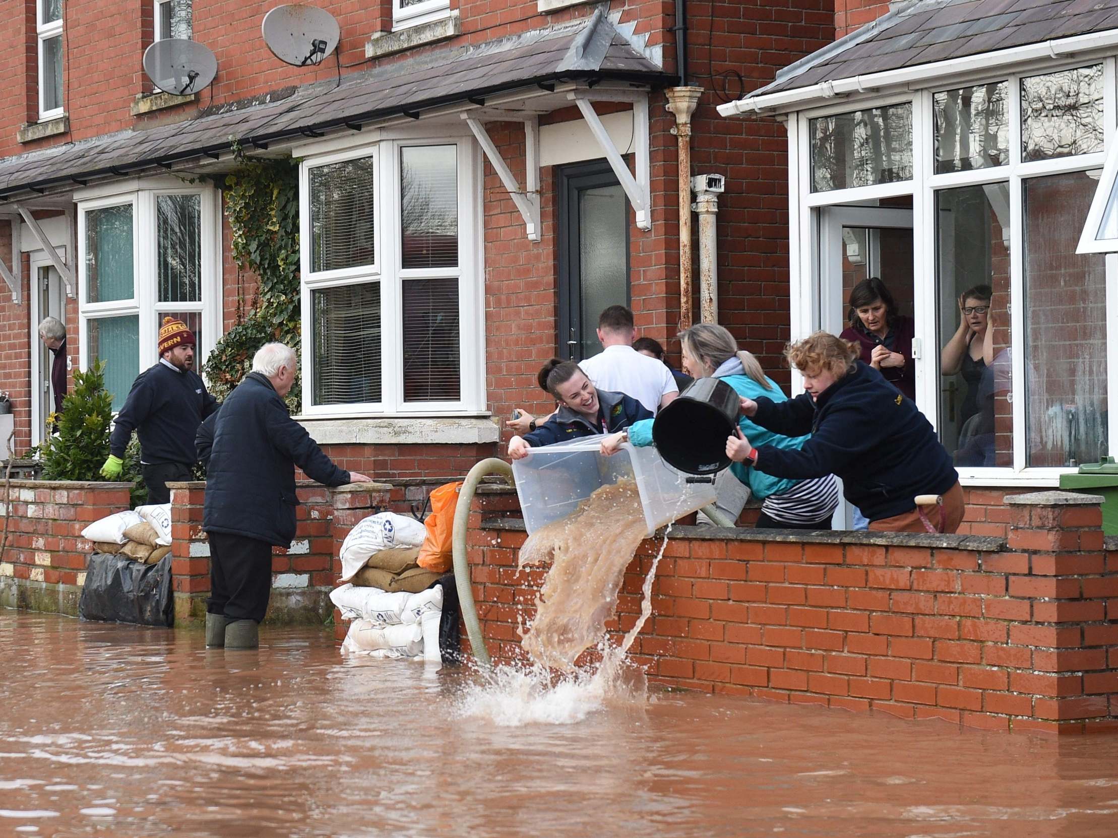Water is bailed out of flooded homes after the River Wye burst its banks in Ross-on-Wye