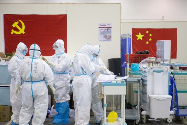 Medical staff in protective suits work at Wuhan Fang Cang makeshift hospital in Wuhan