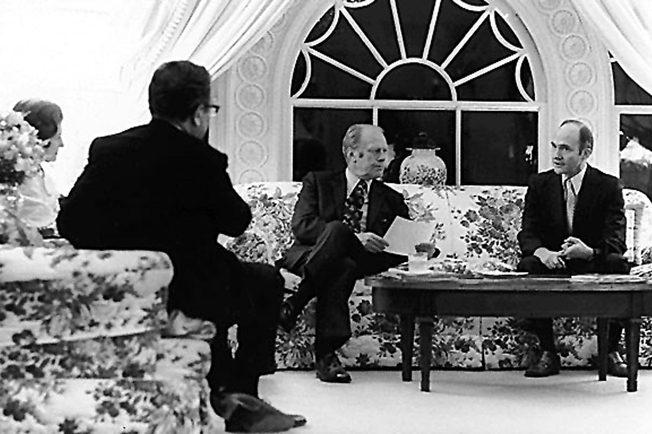 US president Gerald Ford (C) and secretary of state Henry Kissinger (left) are briefed by national security adviser Brent Scowcroft on the evacuation of Saigon