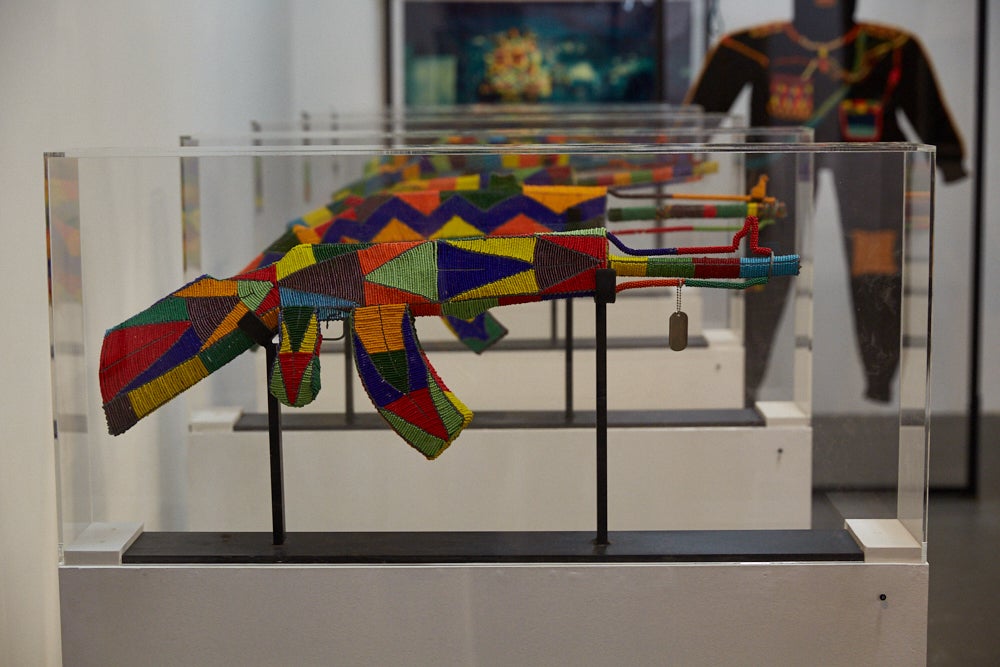 Ziman’s artworks including the AK-47s which are adorned in African beads explore themes of militarisation of the police, oppression, gun violence and inequality