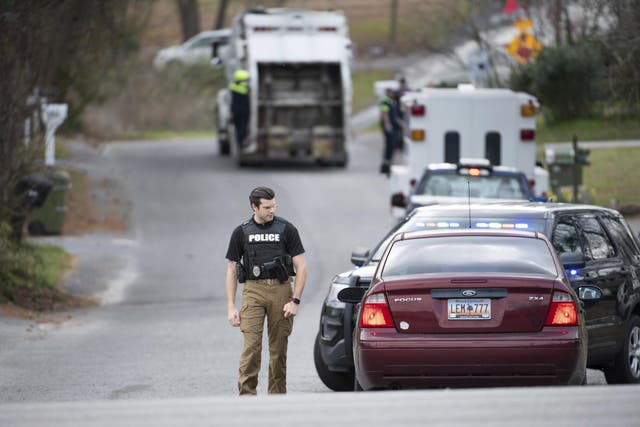 A Cayce police officer approaches a vehicle at a road block near an entrance to the Churchill Heights neighborhood where Faye Swetlik went missing from her front yard.