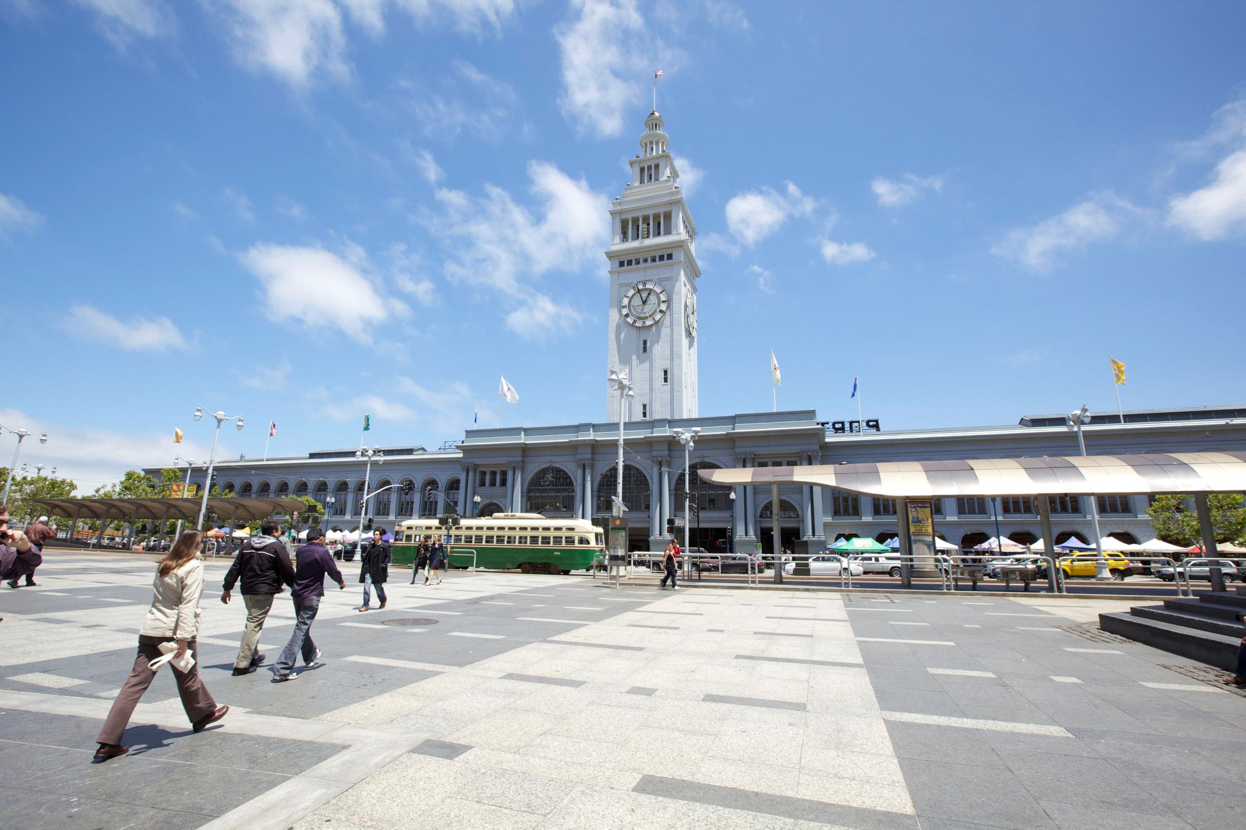 The Ferry Building sits in front of Oakland Bridge