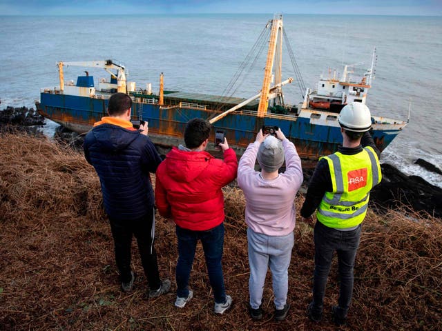 Visitors look over the MV Alta after it washed up near the village of Ballycotton in southern Ireland