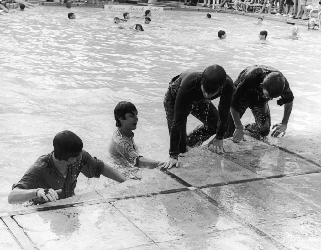 The Beatles climb out of the pool in Nassau