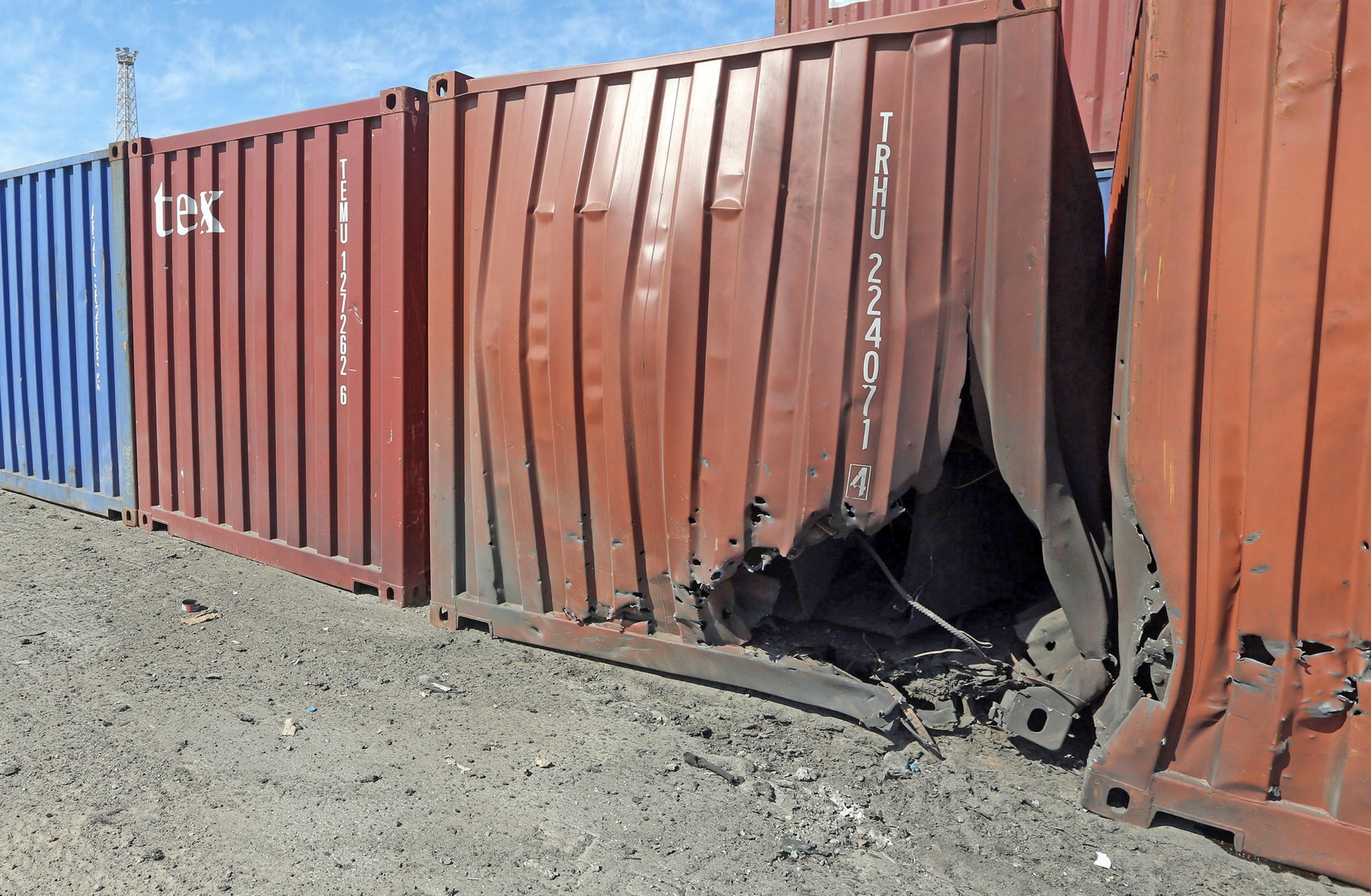 A damaged container is pictured at a port in Libya's capital Tripoli after it was hit by rocket fire