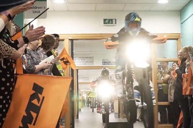 Children get rides up and down the corridors on their electric motorbikes at at Great Western Hospital, in Swindon.
