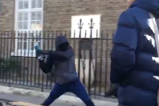 Screen grab of a group of four youngsters using an angle grinder to steal a bike outside London Fields Primary School in Hackney, east London.