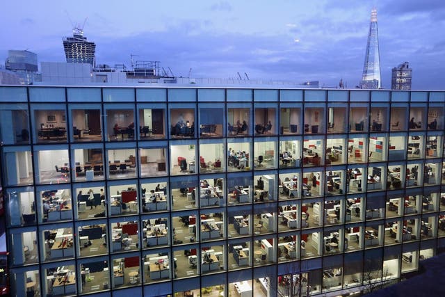People work at dusk on various floors of the modern office development at 20 Cannon Street near St Paul's Cathedral on February 06 2013 London, England