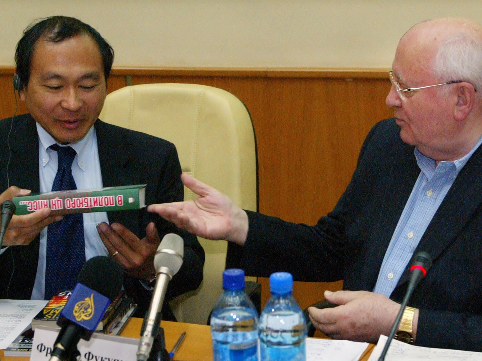 Former Soviet Union president Mikhail Gorbachev gives his book to Fukuyama?during a conference in Moscow (AFP/Getty)