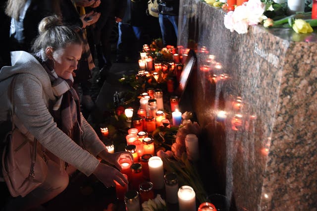 People set up candles during a vigil in Hanau