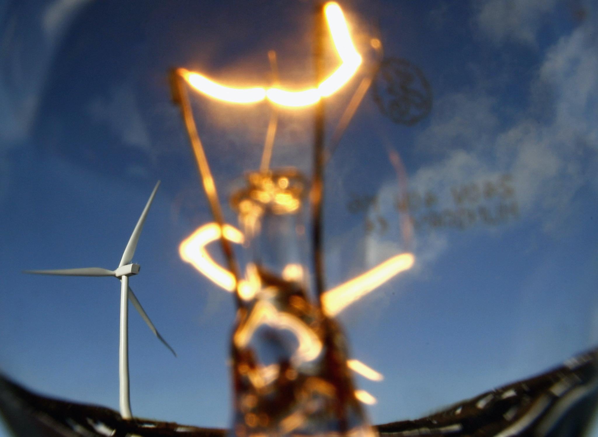 In this photo illustration wind turbines are seen through a light bulb at the Braes of Doune windfarm February 14, 2007 in Stirling, Scotland