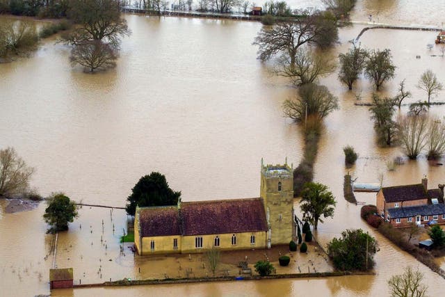 Flood water surrounds a church in Tirley, Gloucestershire, as more rain in northern England could lead to further flooding