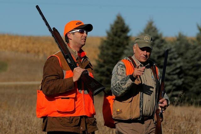 Donald Trump Jr, left, walks with Rep Steve King, Republican for Iowa, after the Colonel Bud Day memorial pheasant hunt in 2017