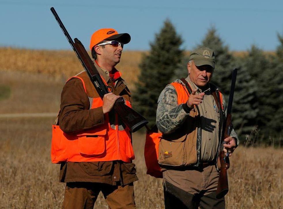 Donald Trump Jr, left, walks with Rep Steve King, Republican for Iowa, after the Colonel Bud Day memorial pheasant hunt in 2017