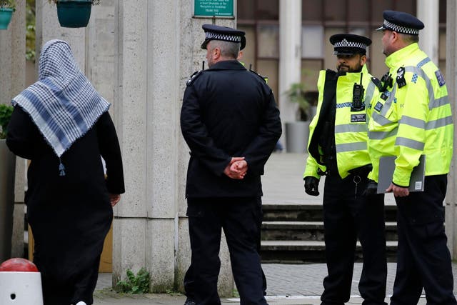 Police officers stand guard as worshippers arrive for Friday Prayers at London Central Mosque near Regent's Park in London on February 21, 2020.