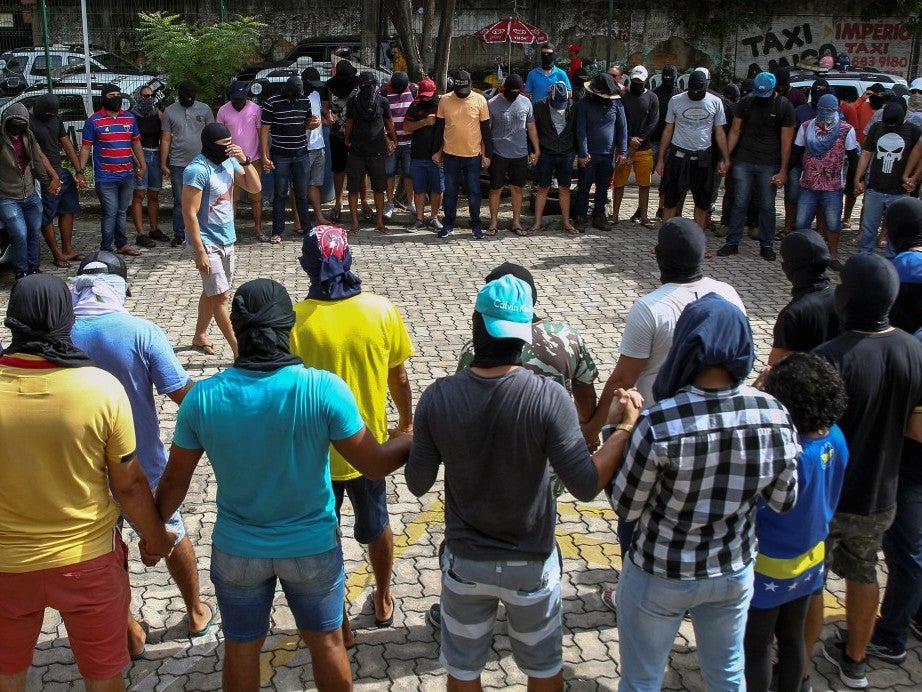 Hooded and masked protesters, supposedly police officers, gather in the 18th Military Police Battalion during the second day of a police strike at the city of Fortaleza in the Ceara state, 20 February 2020