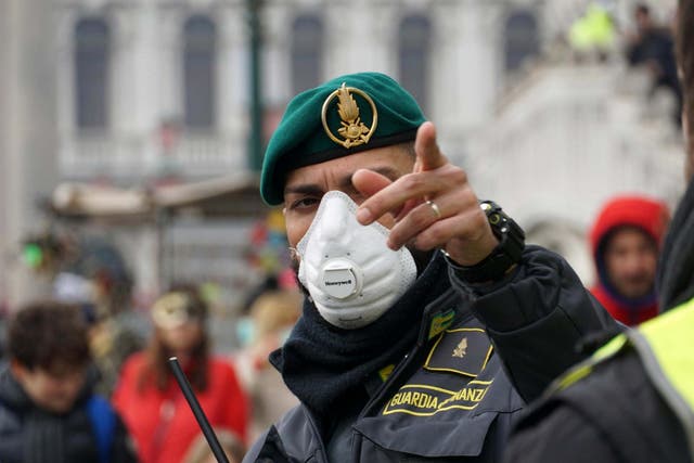 A police officer wears a face mask during the Venice Carnival in Italy