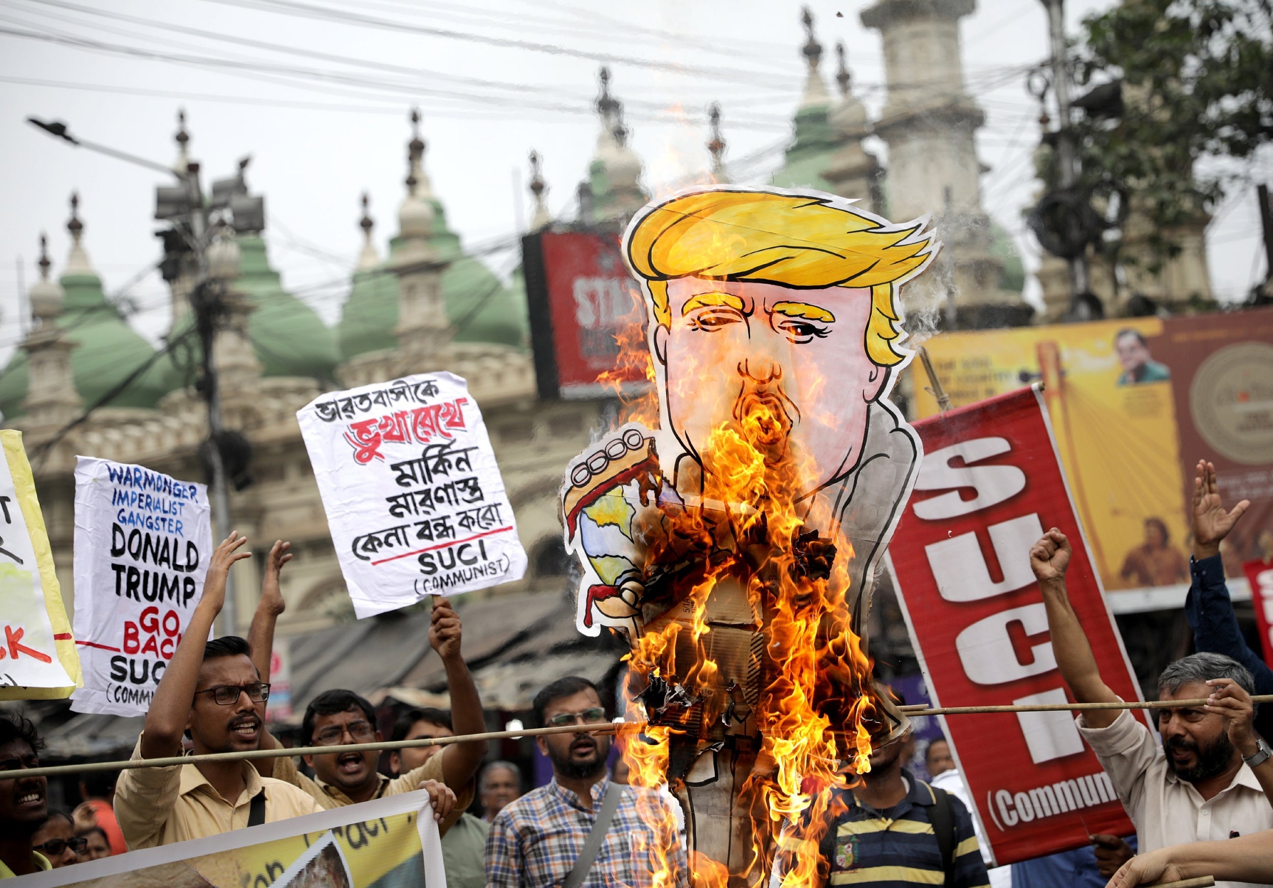 Protesters in Kolkata burn an effigy of Donald Trump as they demonstrate against his visit