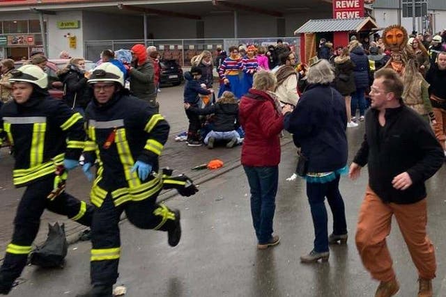 People react at the scene after a car ploughed into a carnival parade injuring several people in Volkmarsen, Germany