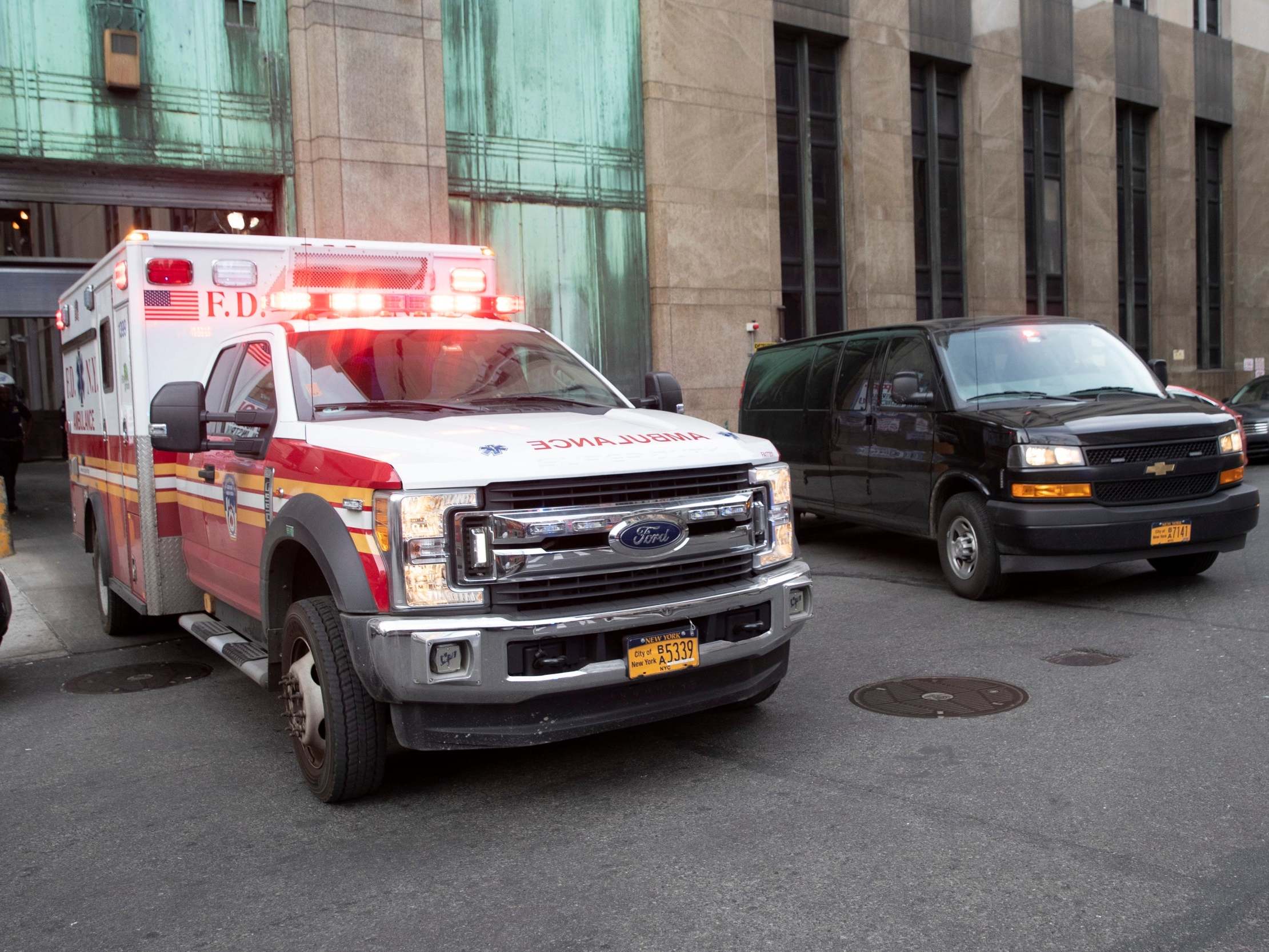 An ambulance carrying Harvey Weinstein is escorted from a courthouse in Manhattan, New York