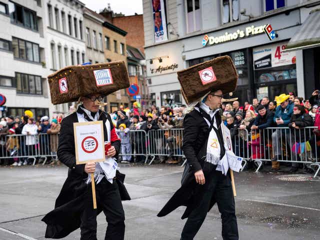 Costumed revellers parade during the 'Zondagsstoet' on the opening day of the Aalst carnival