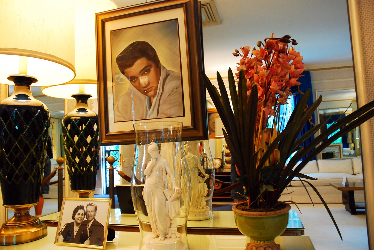 A portrait of Elvis hangs in the living room of Graceland, which was opened in 1982 to pay off debts