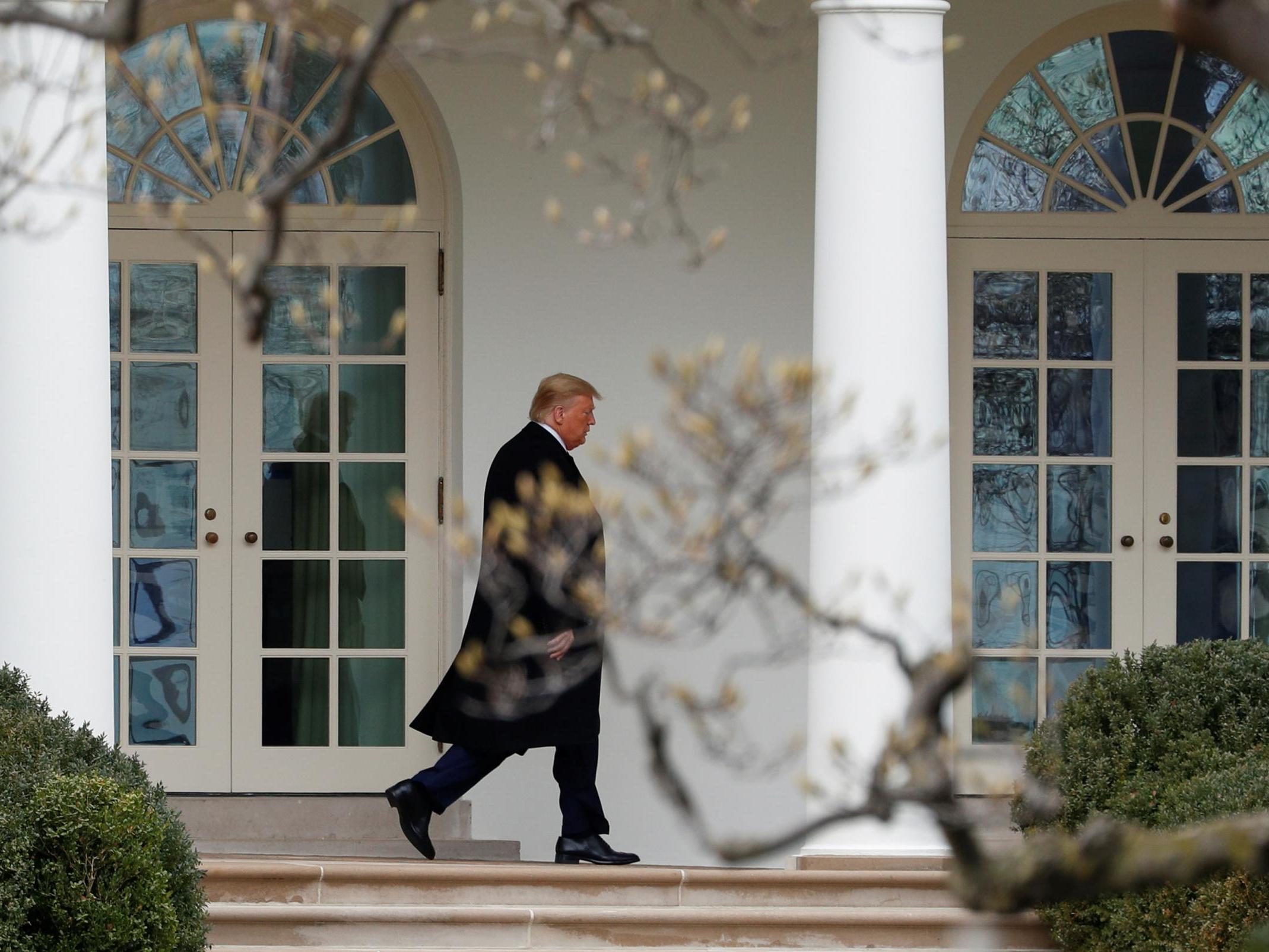 President Donald Trump walks along the colonnade to greet Ecuador's President Lenin Moreno at the White House in Washington, U.S., February 12, 2020.