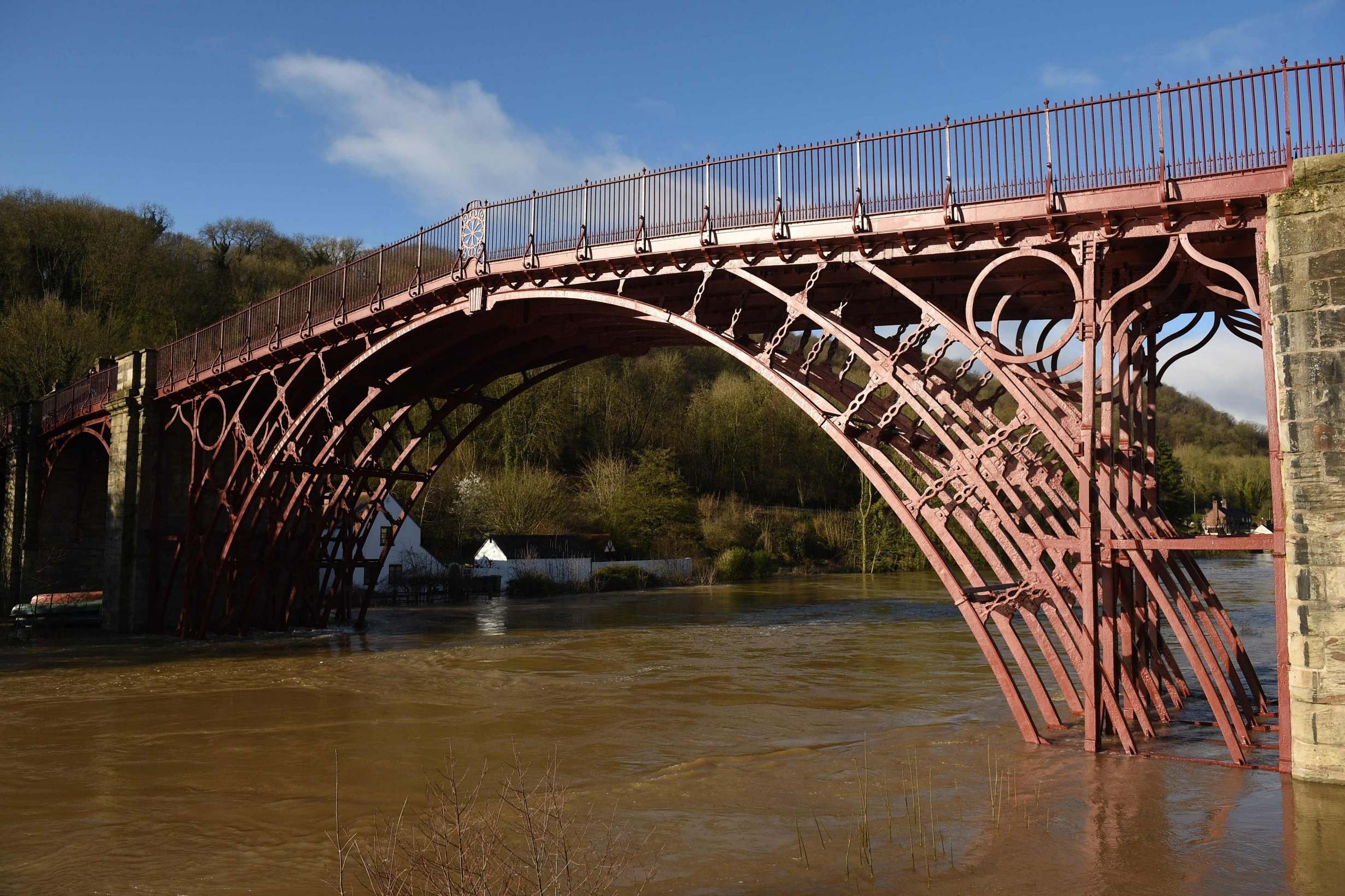 The swollen River Severn that breached emergency defences flowing under The Iron Bridge in Ironbridge, Shropshire, after further rain pushed already high water levels following Storms Ciara and Dennis even higher