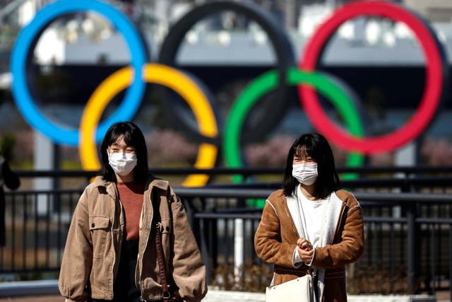 People wearing protective face masks, following an outbreak of the coronavirus, are seen in Tokyo