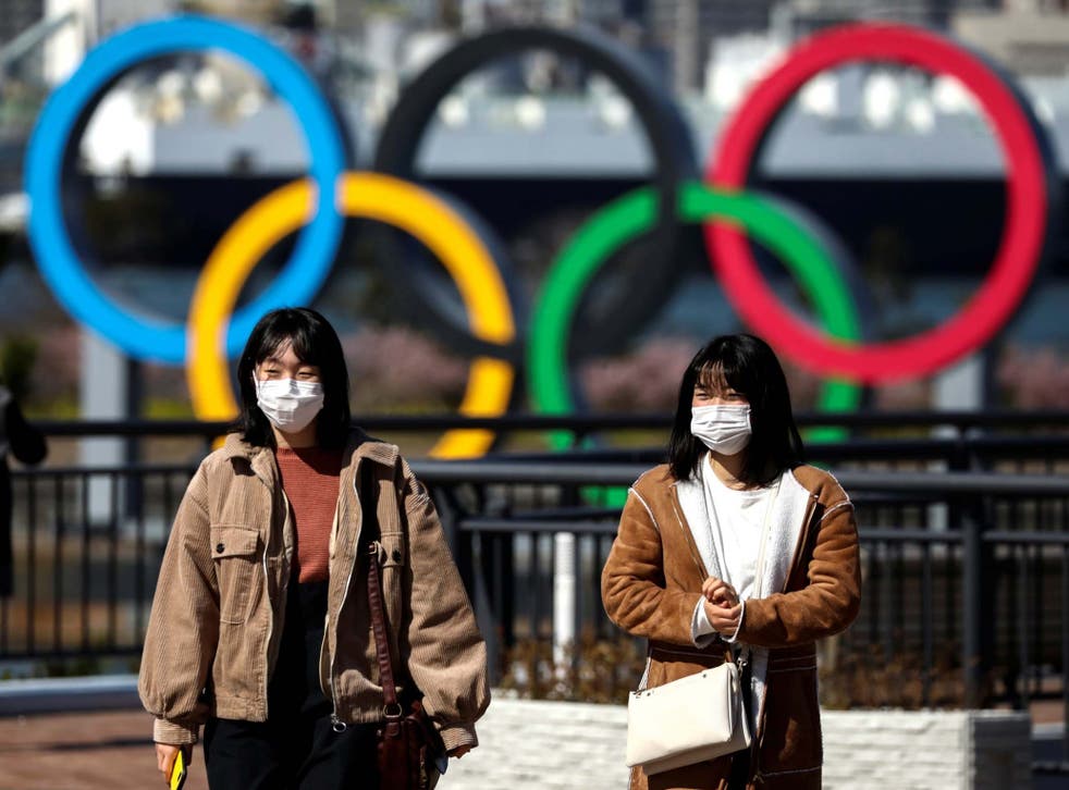 People wearing protective face masks, following an outbreak of the coronavirus, are seen in Tokyo