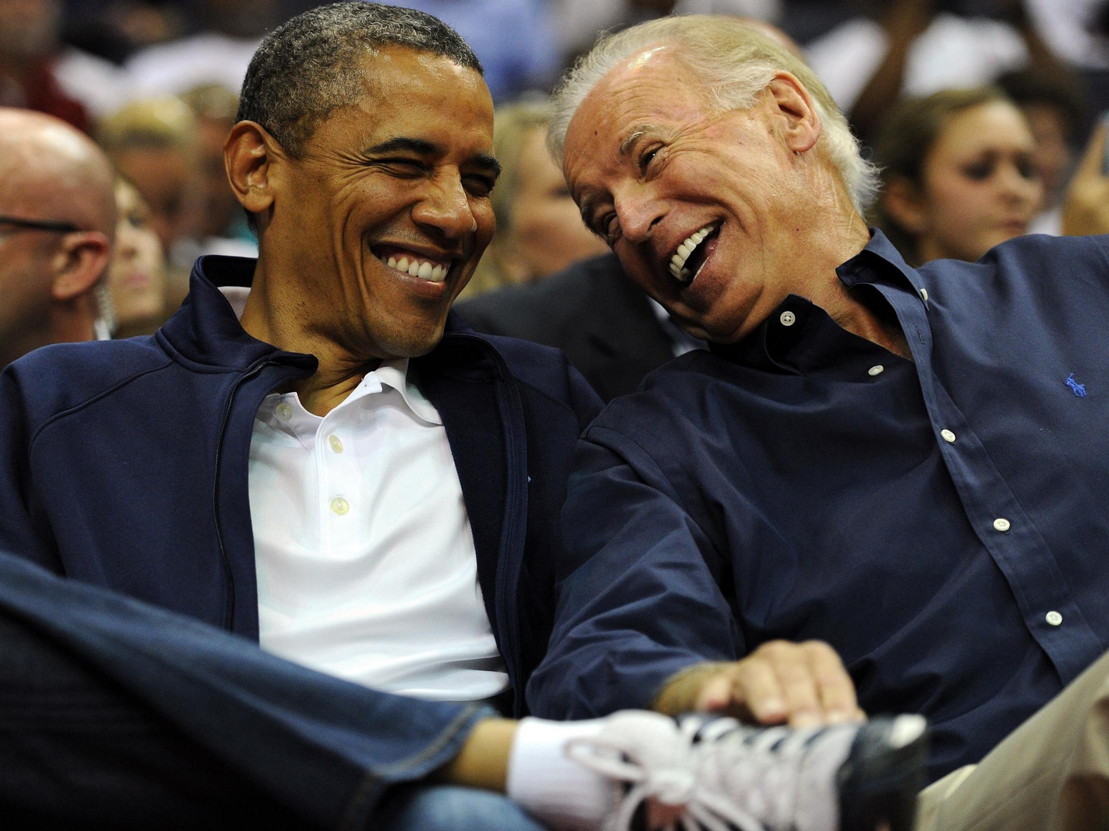President Barack Obama and then vice president Joe Biden share a laugh as the US Senior Men's National Team and Brazil play during a pre-Olympic exhibition basketball game at the Verizon Center on 16 July 2012 in Washington DC