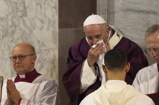 Pope Francis wipes his nose during the Ash Wednesday Mass opening Lent, the forty-day period of abstinence and deprivation for Christians before Holy Week and Easter, inside the Basilica of Santa Sabina in Rome