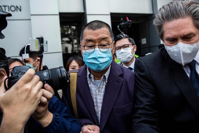 Hong Kong media tycoon and founder of Apple Daily newspaper Jimmy Lai, centre, leaves the Kowloon City police station in Hong Kong on 28 February 2020