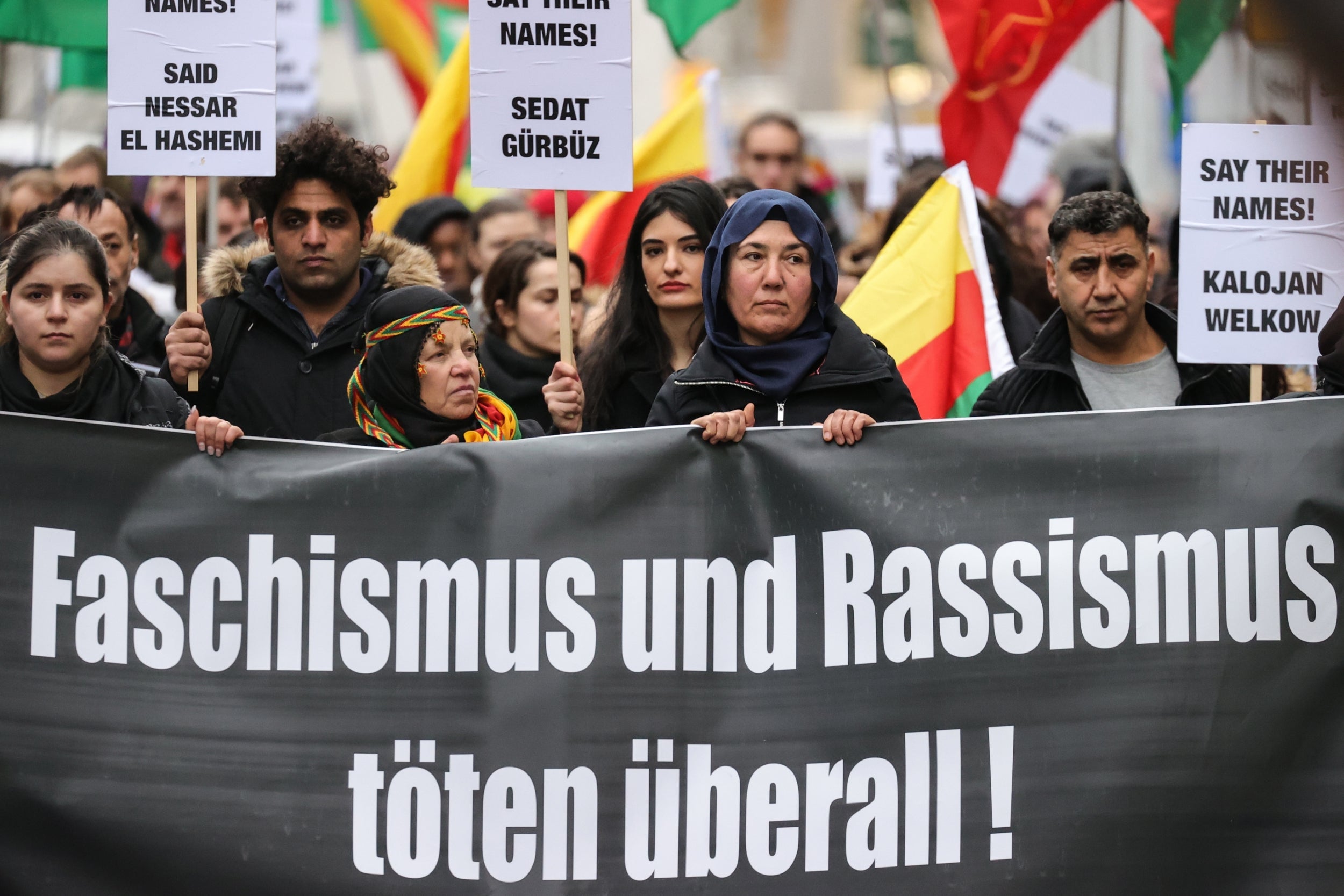 Demonstrators hold a banner reading ‘Fascism and racism kills everywhere!’ as they march in Hanau following the attack