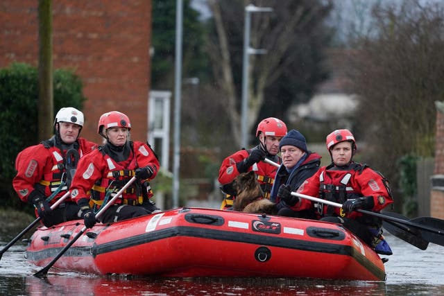 Humberside Fire and Rescue services rescue a resident and his dog from a home in Snaith, East Yorkshire, after the River Aire bursts its banks, 29 February 2020.