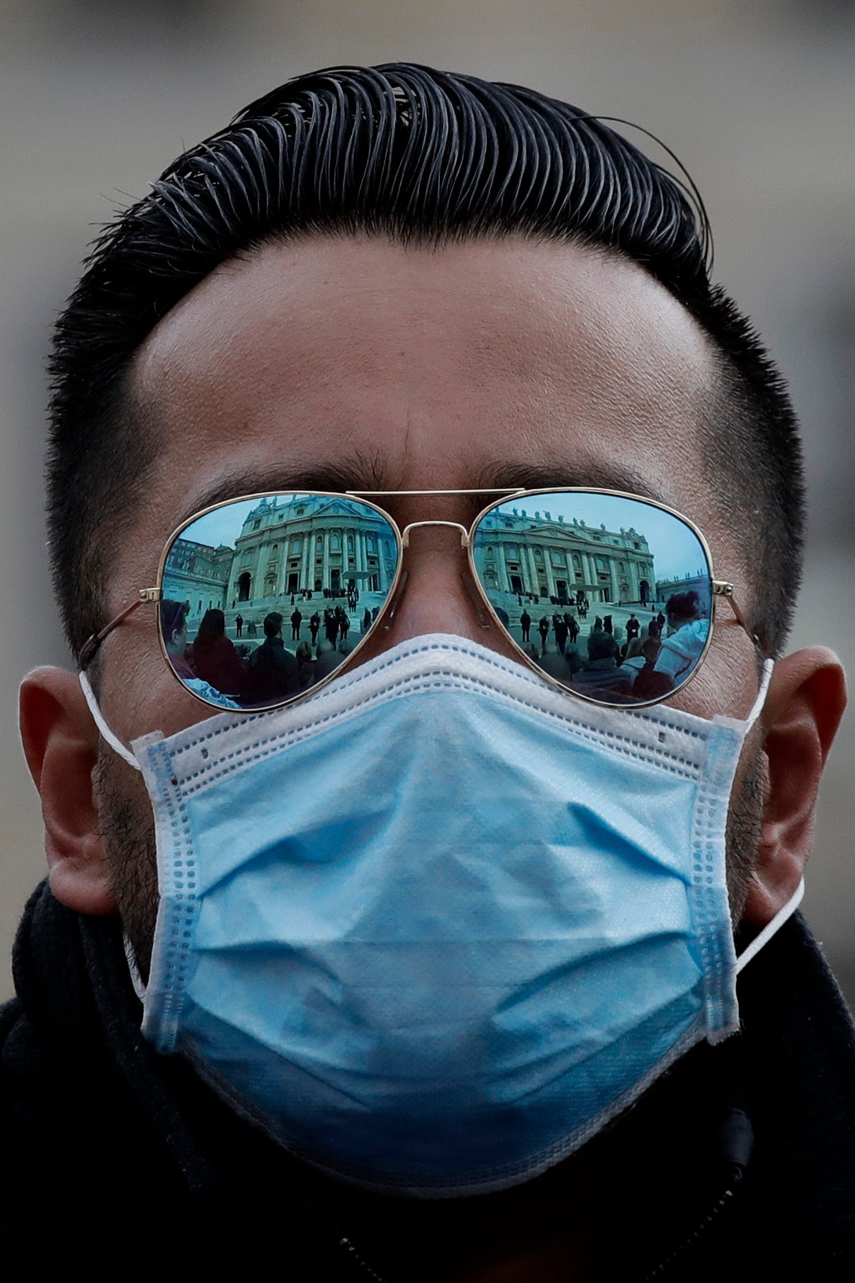 A man wears a mask in St Peter’s Square during Pope Francis’s weekly audience on Wednesday