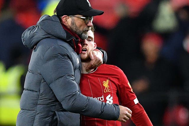 Jurgen Klopp consoles Liverpool full-back Andrew Robertson