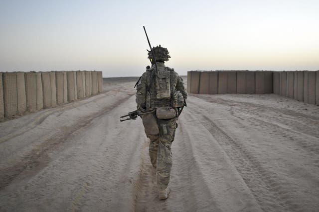 A soldier from the 1st Battalion Royal Regiment Fusiliers leaves the security of the camp walls to conduct a dawn foot patrol in the Nahr-e Saraj district, Helmand Province, Afghanistan